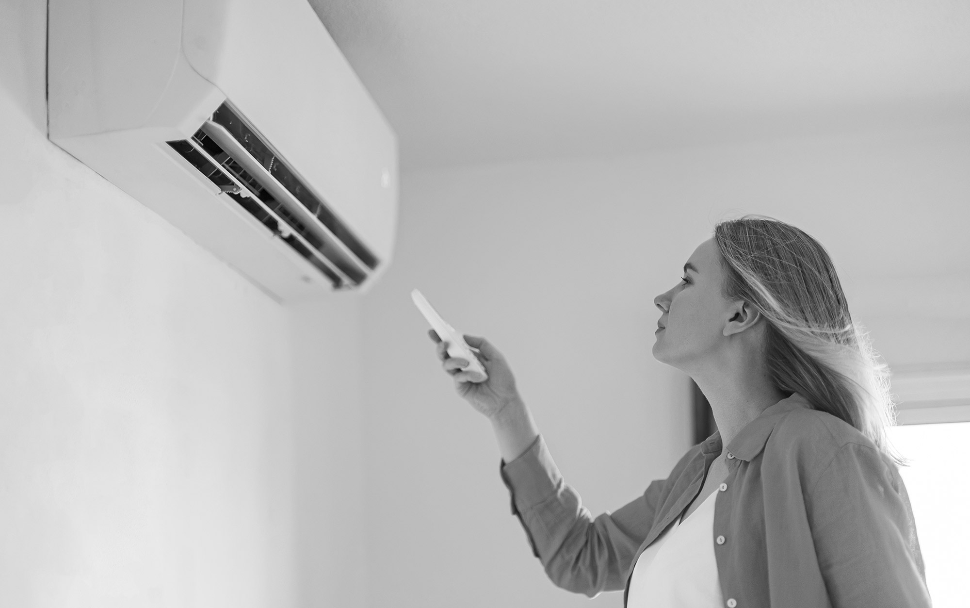 Woman Inspecting Air Conditioner